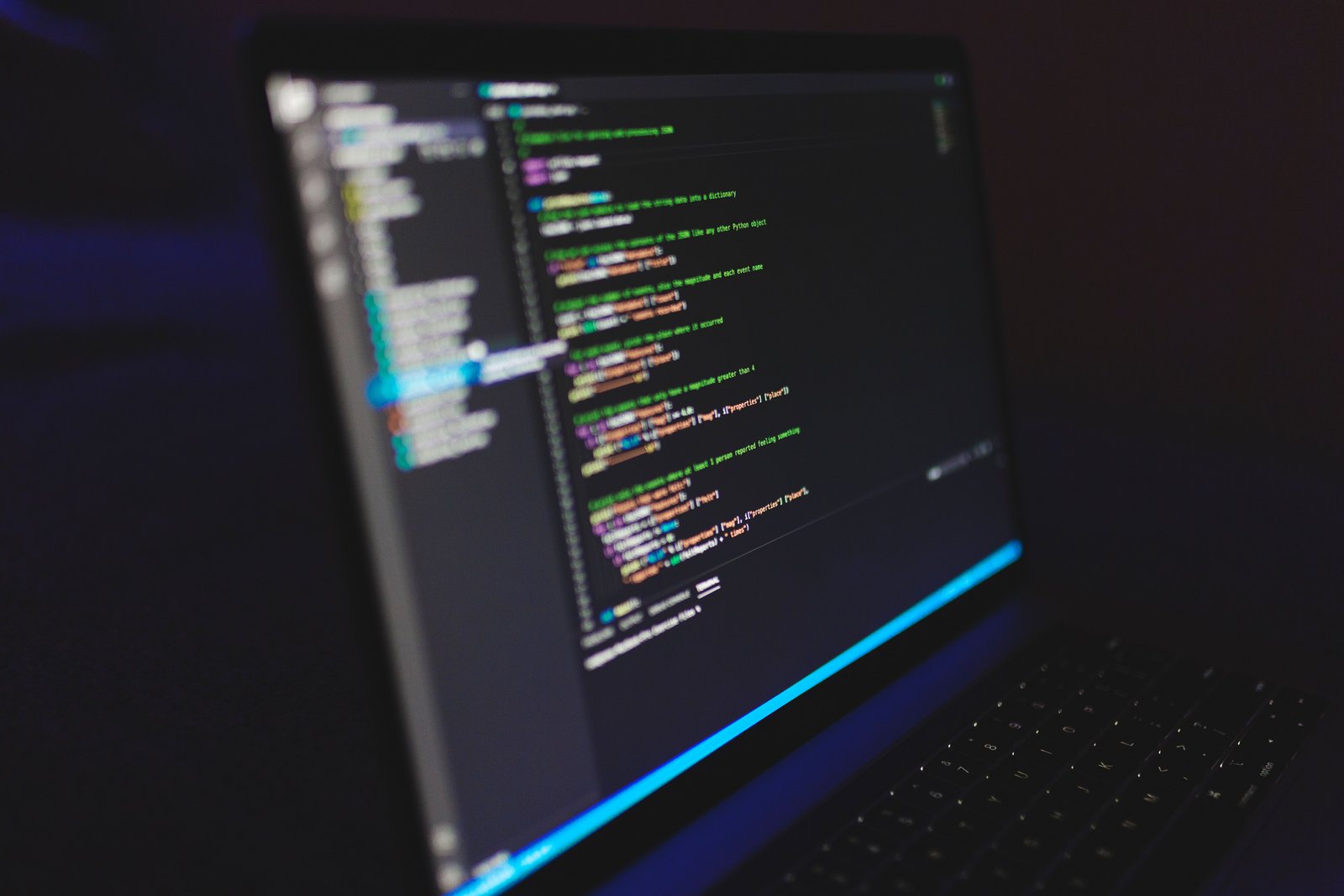 Developer reviewing code on a laptop to test AI-generated software