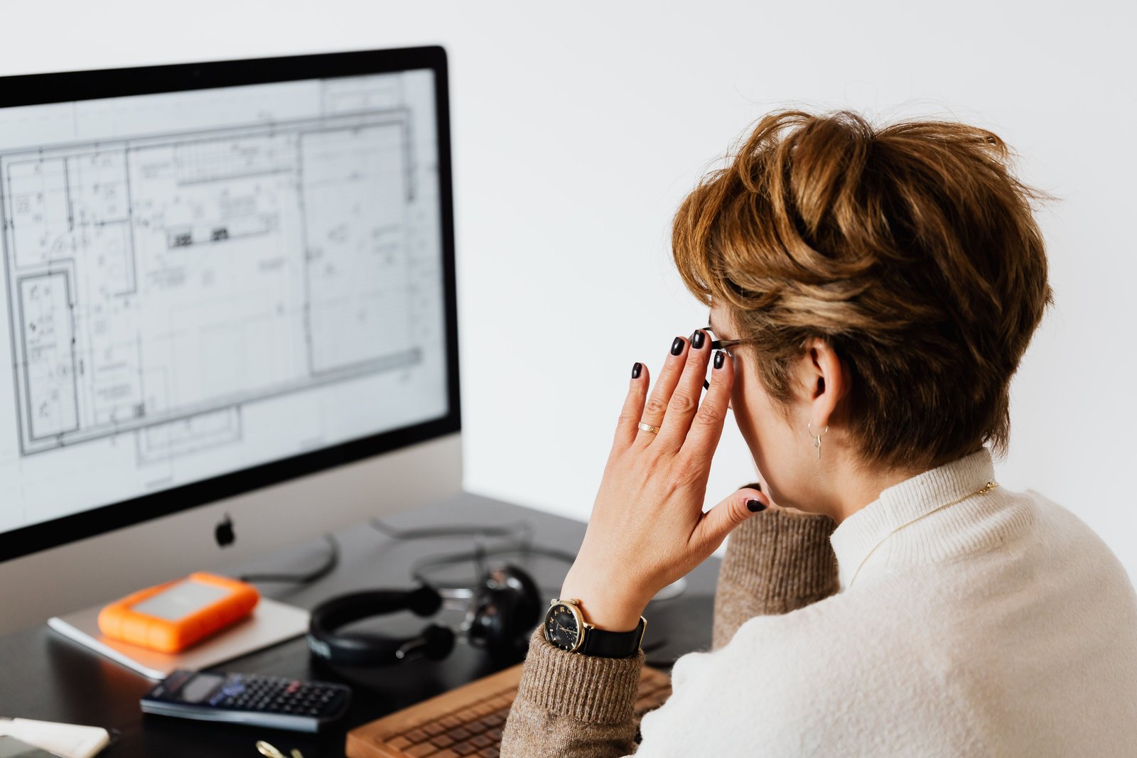 Person checking information on a laptop before trusting an AI answer